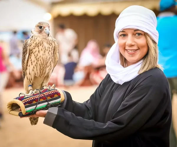 women posing with falcon